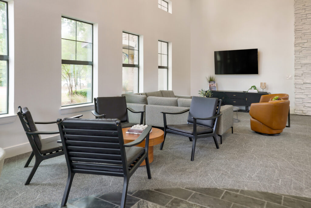 Clubhouse lounge with sofas and chairs and TV